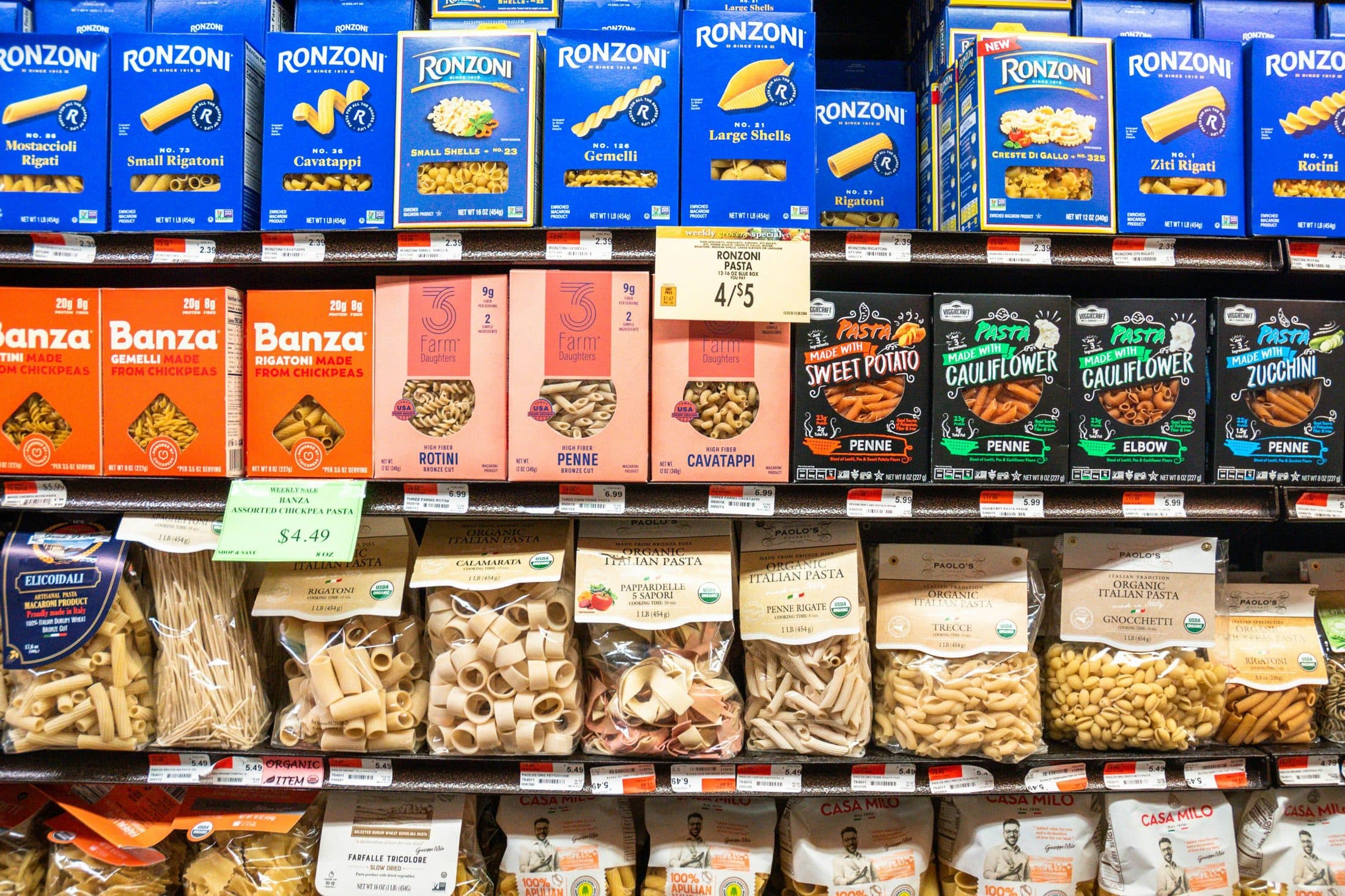Grocery shelf packed with pasta brands